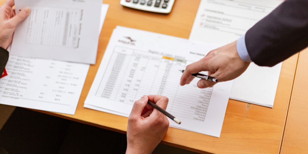 Lawyers pointing at paper Developing New Practice Areas within a Firm